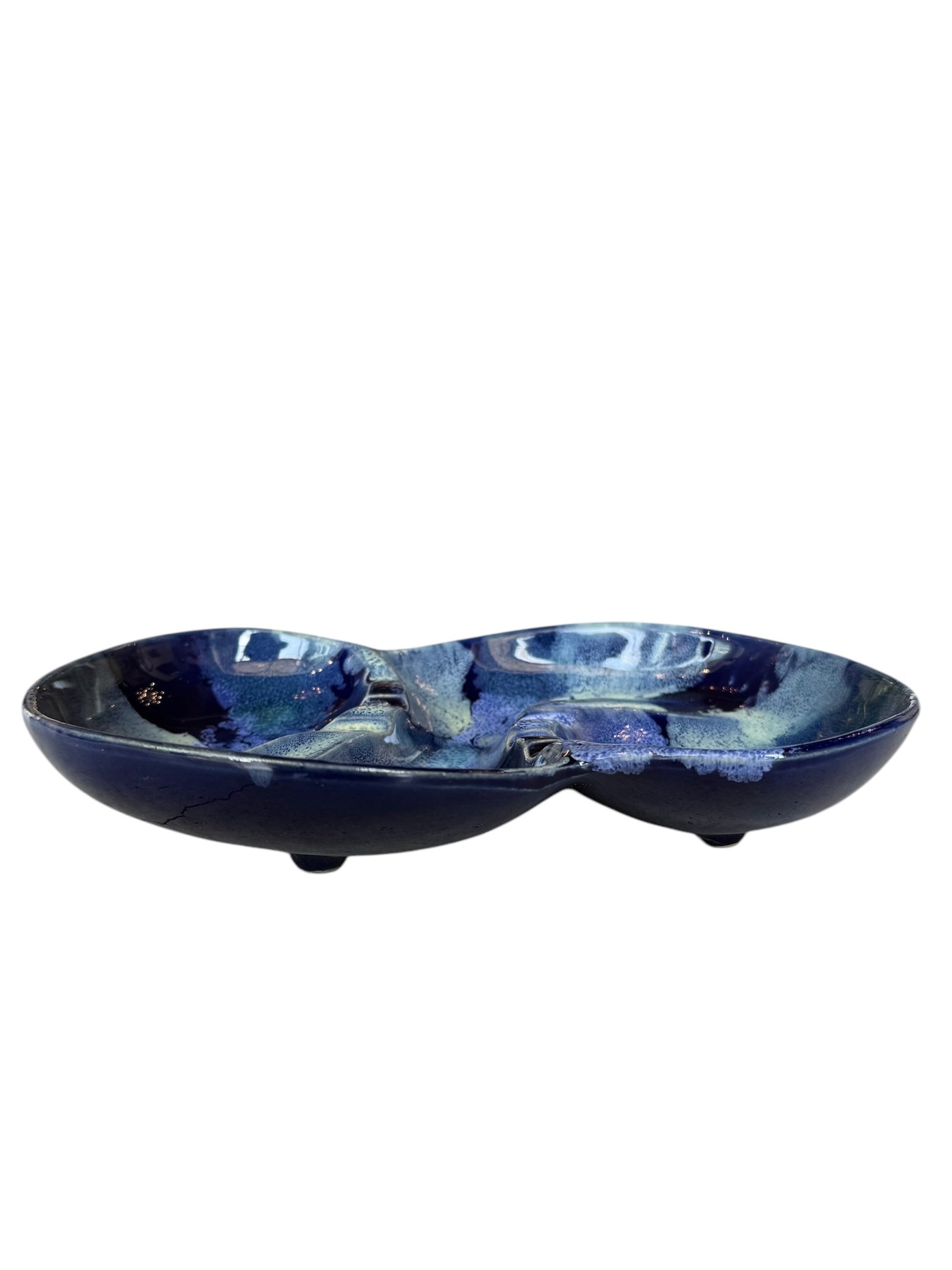 Vintage McCoy ashtray. Glazed in dark blue and marbled with lighter blues. The bottom is stamped 'McCoy USA.'"