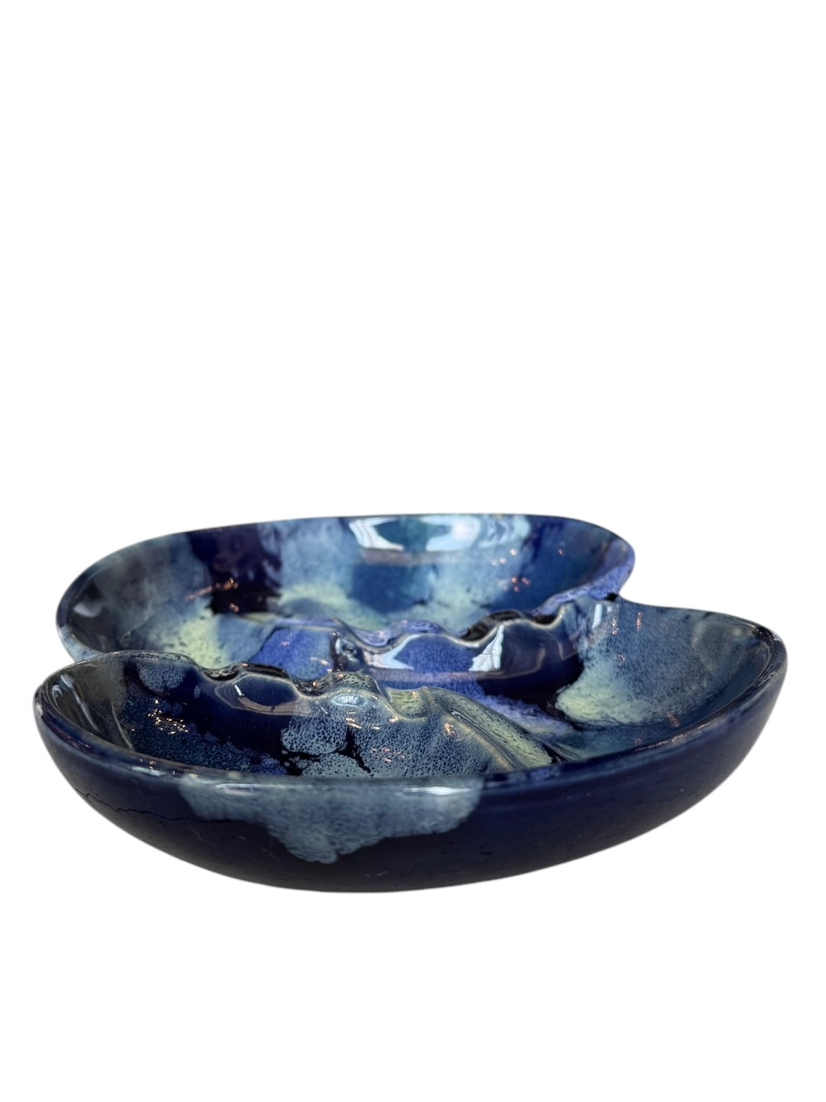 Vintage McCoy ashtray. Glazed in dark blue and marbled with lighter blues. The bottom is stamped 'McCoy USA.'"