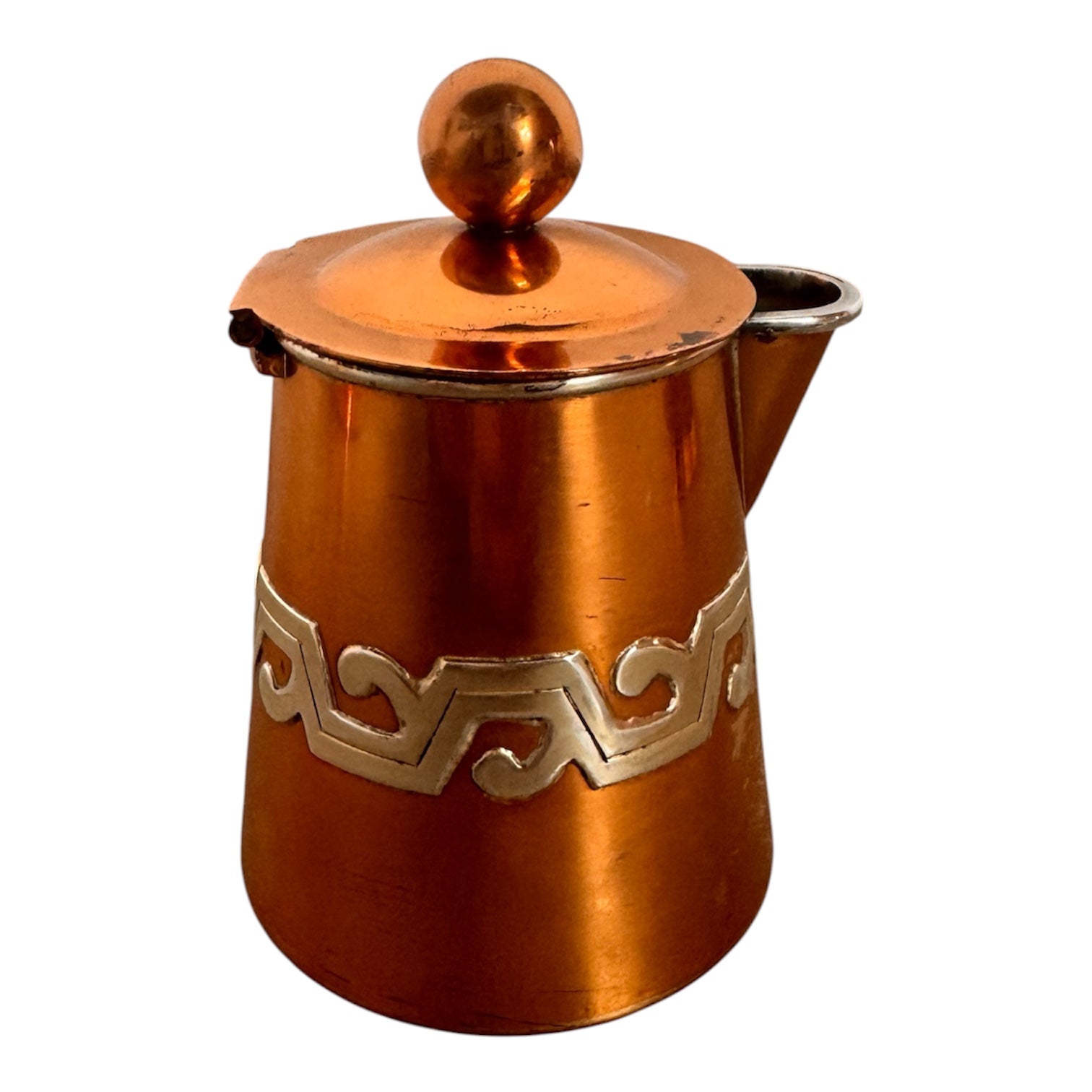 The set includes a large, rectangular, hammered copper tray with geometric openwork handles. Resting on the tray is a tall, slightly tapered copper coffee pot with a wooden handle, a matching smaller creamer pitcher with a similar wooden handle, a lidded sugar bowl, and a tiny matching metal cup or jigger. To the right off the tray sits a large, spherical copper water pitcher or jug with a wide mouth and ice lip.