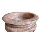 A carved pink granite planter with a leaf pattern, designed for indoor use without drainage.