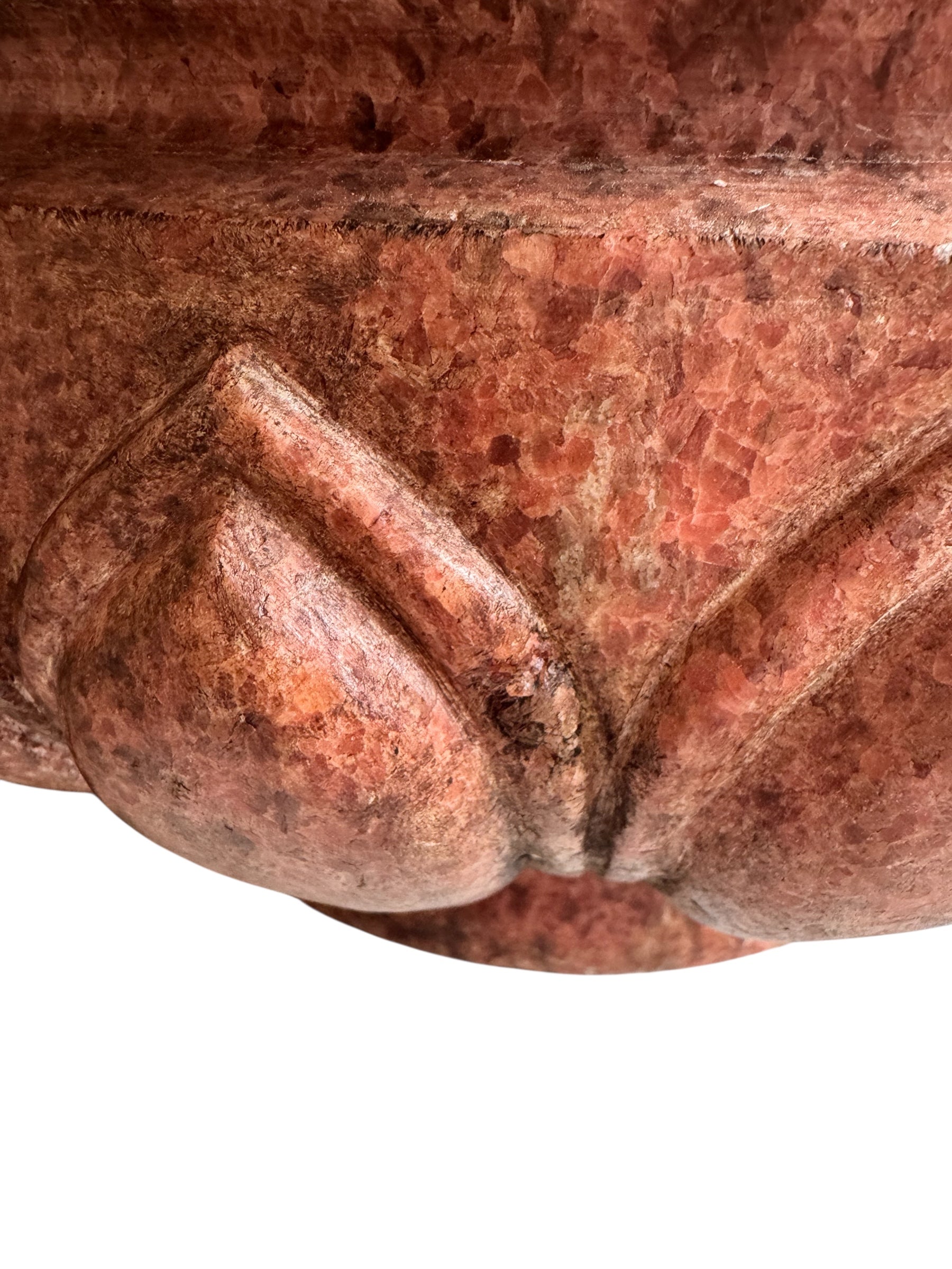 A carved pink granite planter with a leaf pattern, designed for indoor use without drainage.