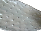 A white, glazed ceramic platter in the shape of a prickly pear cactus pad with attached prickly pear fruit. The surface has raised dots representing spines. 