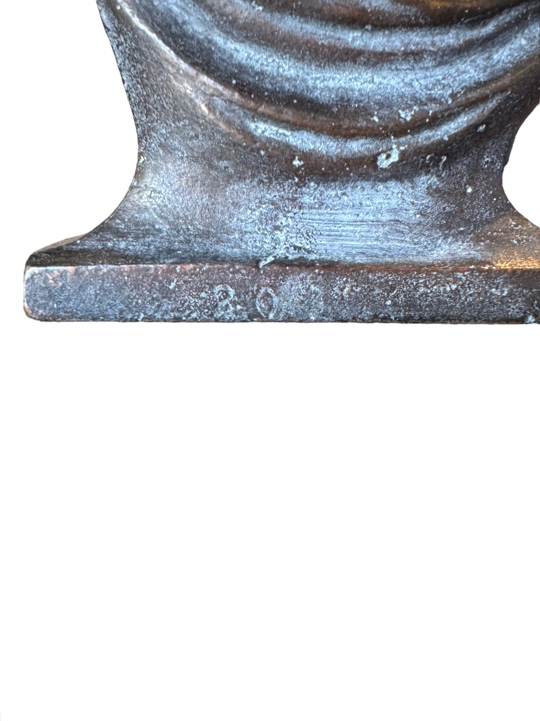 Two cast iron bookends in the Art Deco style. Each features a nude female figure leaning gracefully with one leg extended, posed atop a stylized wave or drape. The bookends have a bronze-colored finish and a vintage appearance.