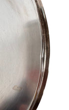 Round St. James silver-plated lidded serving dish from the 1980s, featuring a minimalist modernist design with geometric side handles and a sculptural, biomorphic finial, showing visible vintage wear and pitting on the metallic surface.