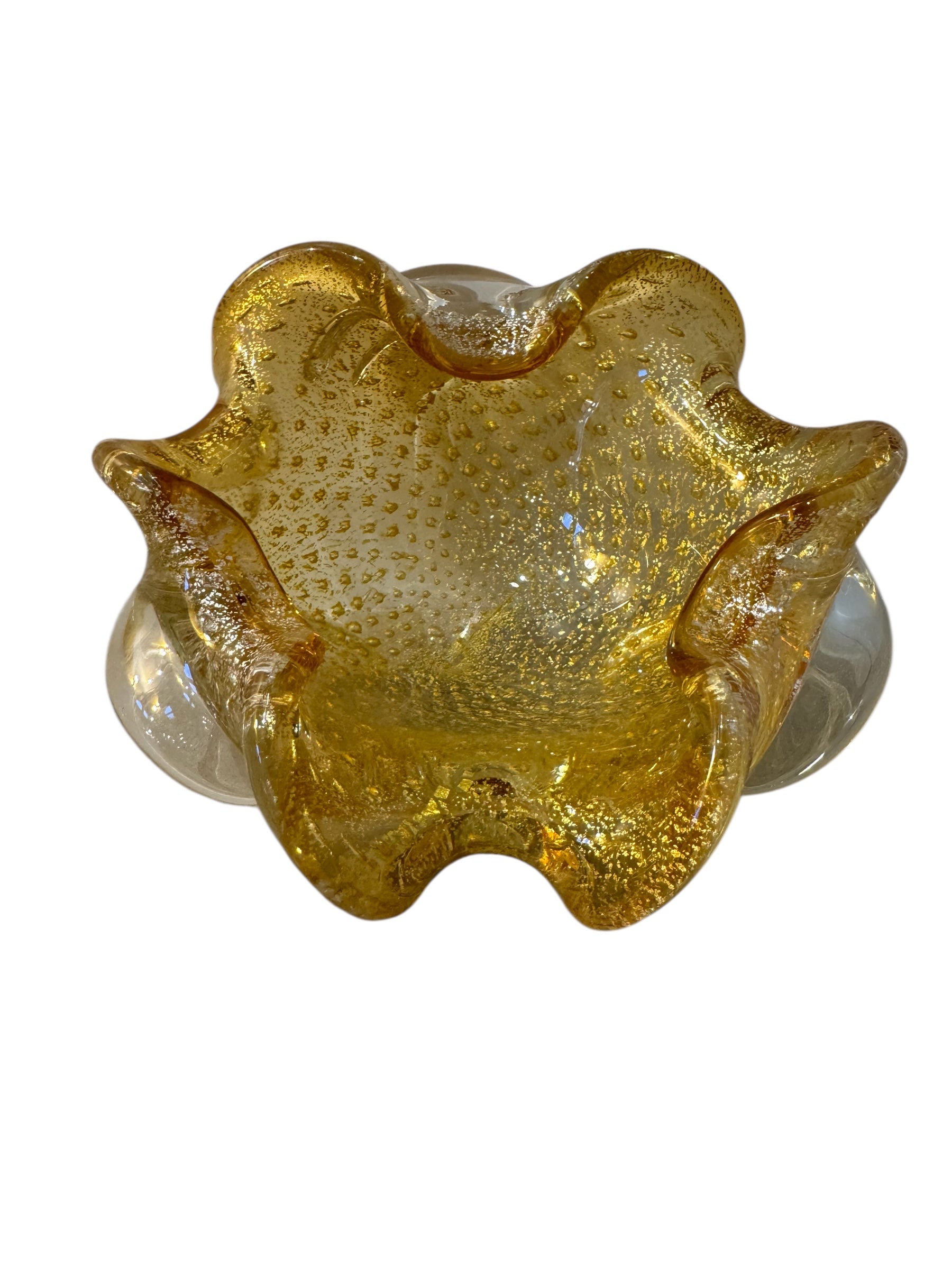 A  vintage Italian Murano glass bowl with a yellow hue, gold Aventurine inclusions, and a bubbly (Bullicante) texture. The bowl is flower-shaped with crimped edge