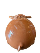 Terracotta colored ceramic Highland cow sculpture with a shaggy coat and curved horns