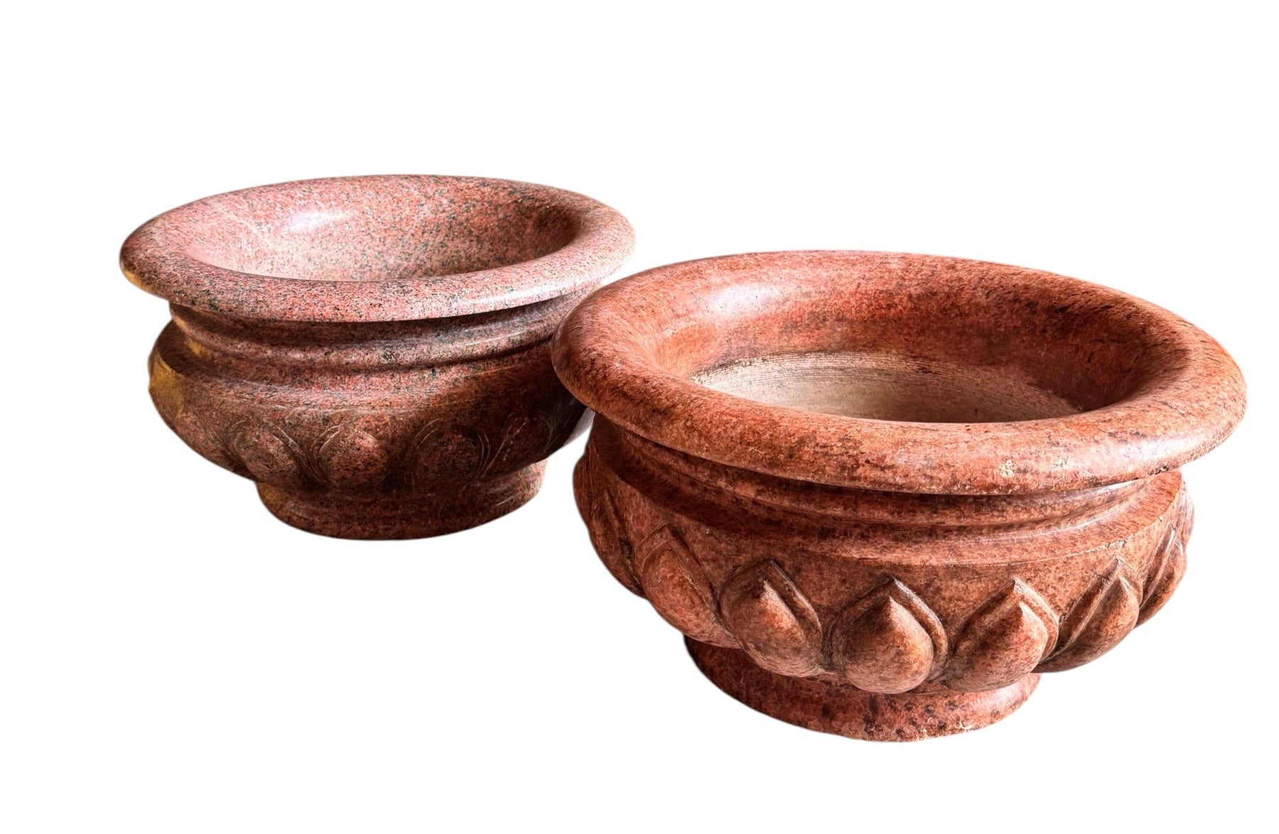A carved pink granite planter with a leaf pattern, designed for indoor use without drainage.