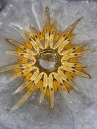 A hand-blown art glass vase with a scalloped, tulip-shaped rim, featuring an amber-to-clear color gradient and a ribbed base