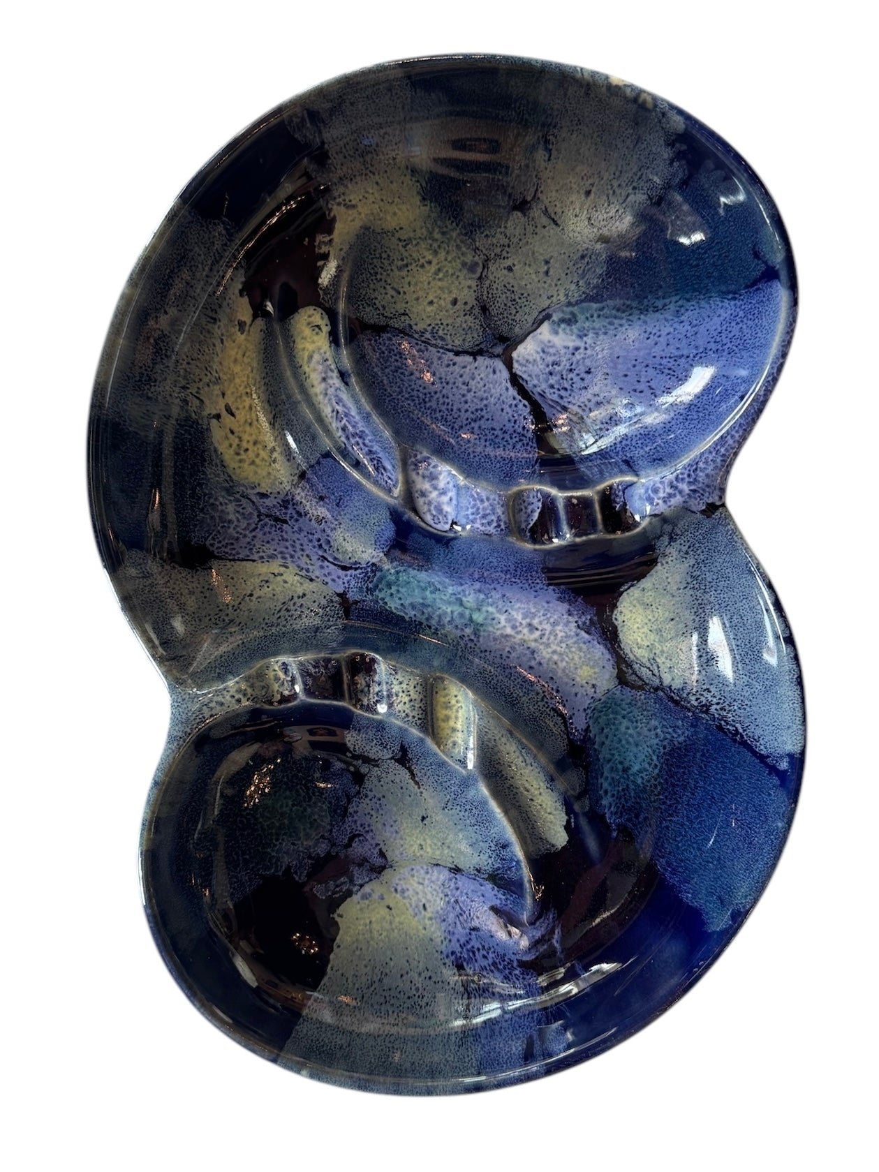 Vintage McCoy ashtray. Glazed in dark blue and marbled with lighter blues. The bottom is stamped 'McCoy USA.'"