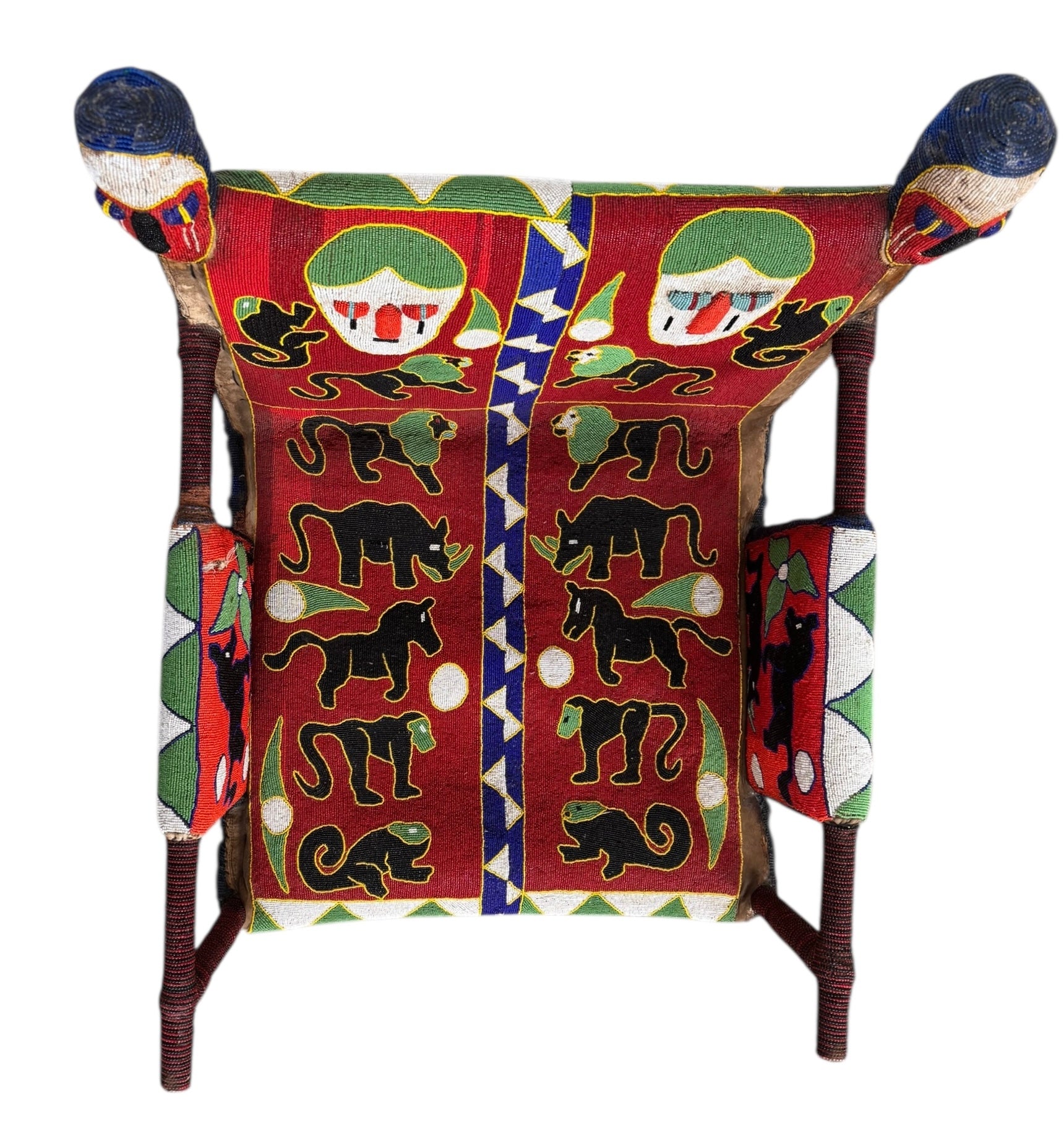 Close-up of a Yoruba beaded armchair, featuring vibrant red, blue, and green beads in a pattern of stylized masks and animals such as lions and zebras