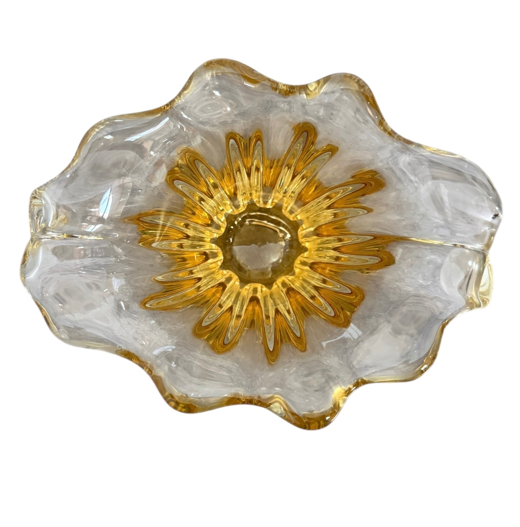 A hand-blown art glass vase with a scalloped, tulip-shaped rim, featuring an amber-to-clear color gradient and a ribbed base