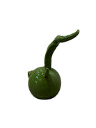 Glossy green ceramic pig sculpture with exaggerated, upward-curving horns and a snout.
