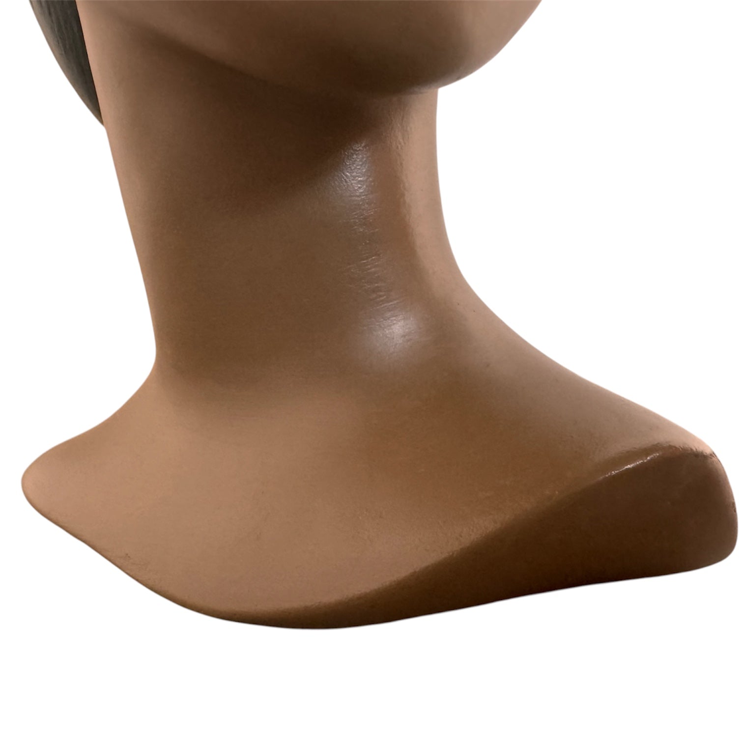 a vintage ceramic bust featuring a woman with brown skin, dark eyes, and orange lips. Her black hair is sleek and parted on the side, pulled back into a low style. She wears a small, round white earring in her right ear lobe. The bust includes her head, neck, and the upper part of her shoulders