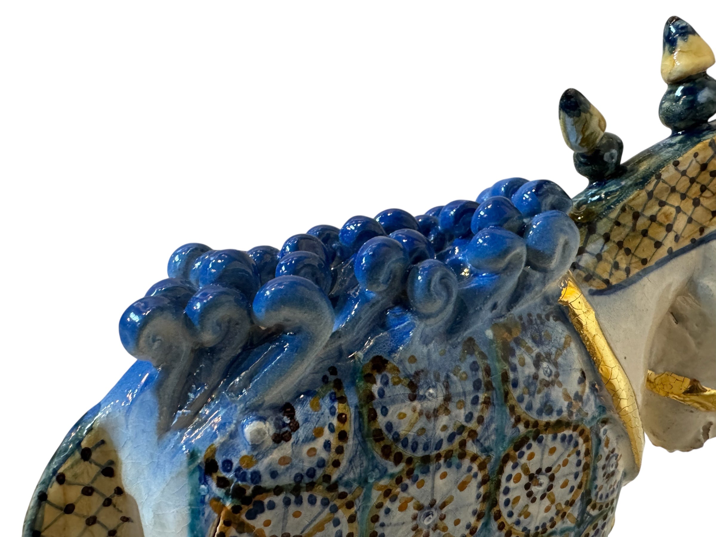 Ceramic horse by Domenico Pinto, featuring a white glazed body, geometric quilting on the saddle, a decorative crown with black and gold accents, and 24Kt gold detailing. The horse stands on four legs and is placed on a white base.