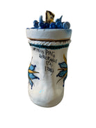 Close-up of Domenico Pinto's 'Mare Dentro' ceramic sculpture: foot, ship with gold sail, Apulian style