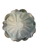 A Murano art glass bowl featuring a vibrant red interior encased in white glass, with a decorative ruffled edge. The piece is handblown, showcasing the Incamiciato technique.