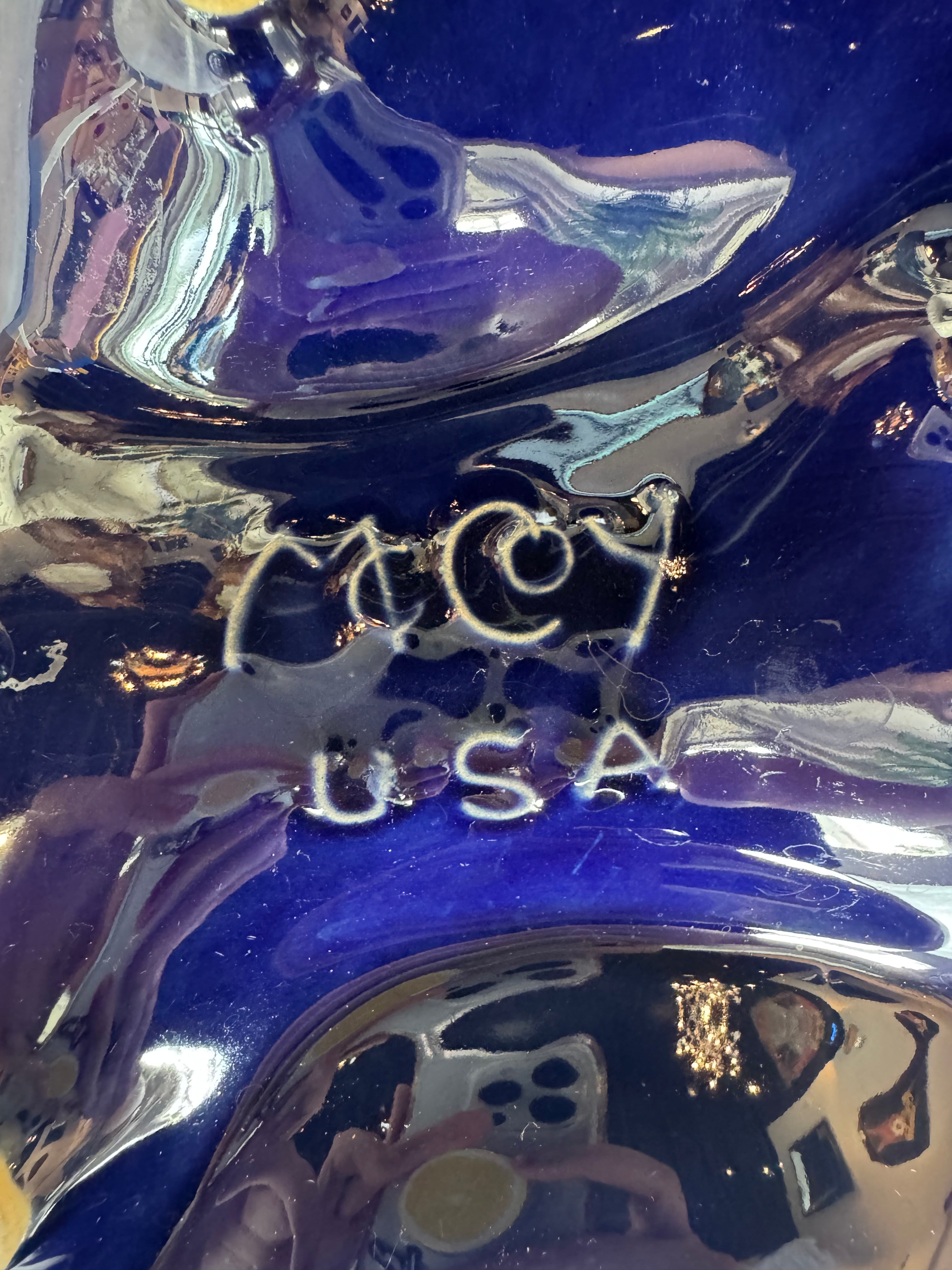 Vintage McCoy ashtray. Glazed in dark blue and marbled with lighter blues. The bottom is stamped 'McCoy USA.'"