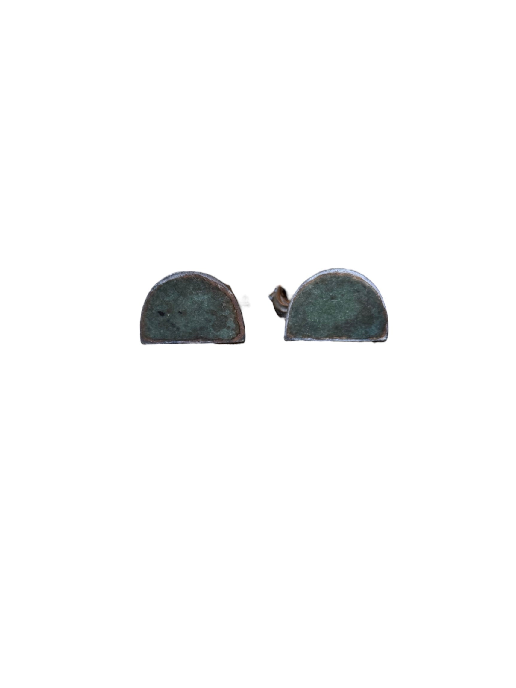 Two cast iron bookends in the Art Deco style. Each features a nude female figure leaning gracefully with one leg extended, posed atop a stylized wave or drape. The bookends have a bronze-colored finish and a vintage appearance.