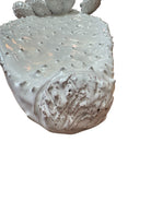 A white, glazed ceramic platter in the shape of a prickly pear cactus pad with attached prickly pear fruit. The surface has raised dots representing spines. 
