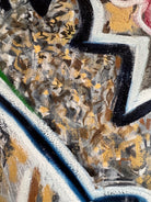 A close-up, angled view of an abstract oil painting titled 'Topography' by Robert Wymer. The painting's edge reveals thick, textured swirls of brown, gold, red, green, and white paint. It is framed in a natural light-brown teak wood frame, with a visible corner joint where two pieces of wood meet