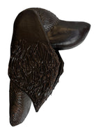 A dark, chocolate-brown ceramic sculpture by Enza Fasano depicting the stylized head of a hunting dog, such as a pointer or hound. The piece features a smooth, elongated snout and large, floppy ears with a textured, feathery finish that contrasts with the sleek crown of the head. The minimalist design emphasizes the dog's elegant profile and long neck.