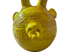 Yellow ceramic sculpture titled 'The Ram Oracle' by Enza Fasano, featuring a round body with intricate, hand-incised patterns and long, stylized ram-like horns