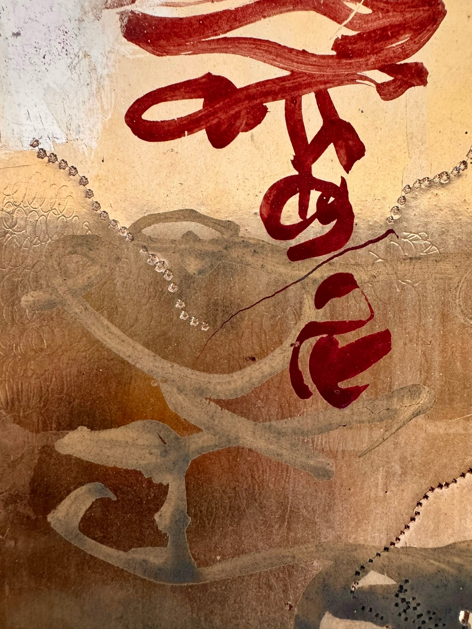 A vertical abstract work on a weathered gold-leaf panel. The upper section features bold, dark red calligraphic symbols resembling distorted kanji or script. Below, delicate, dotted white lines wind through the composition like strings of pearls or constellations. A slender, vertical form in vibrant red stands on the right, while muted, smoky-grey washes of paint ground the bottom of the piece.