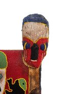 Close-up of a Yoruba beaded armchair, featuring vibrant red, blue, and green beads in a pattern of stylized masks and animals such as lions and zebras
