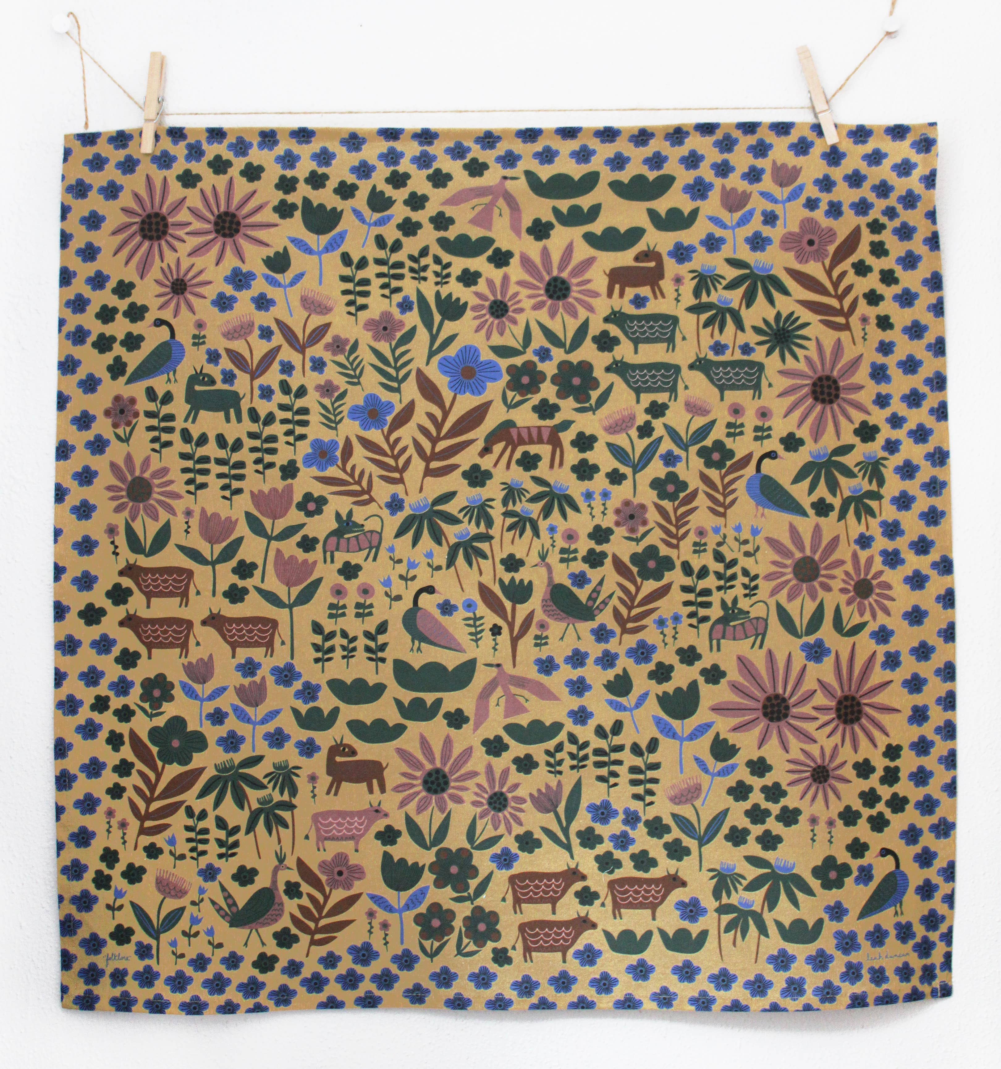 Patterned fabric with animals and flowers on a beige background