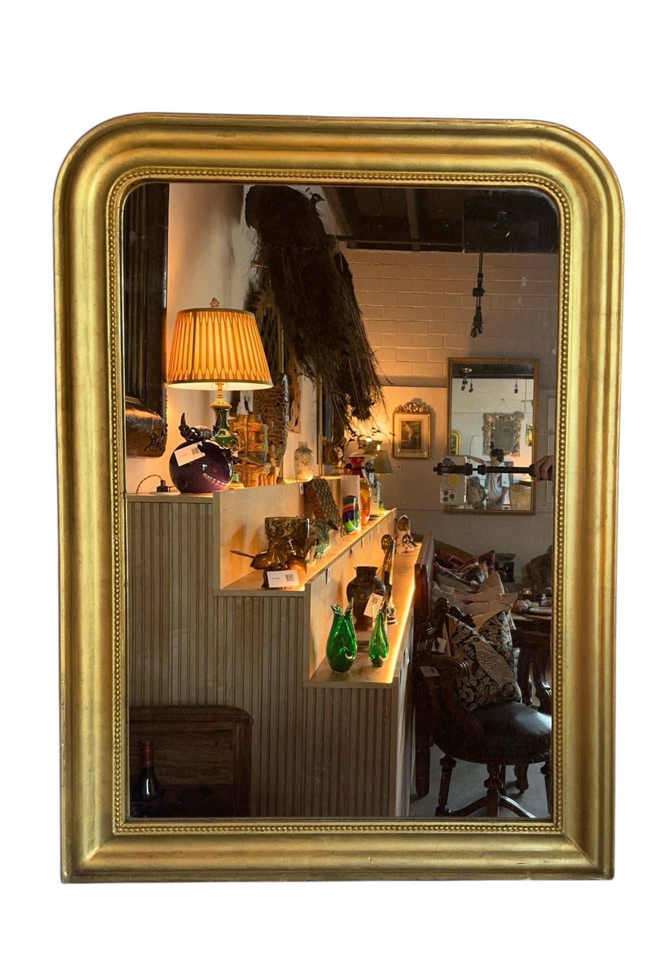 Mid-19th century gilt mirror with a softly rounded frame and beaded details.