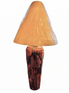 Two table lamps made from repurposed teak wood vases. The bases are tall and tapered, featuring a rugged, mosaic-like texture composed of various pieces of dark, polished teak wood with visible natural grain and crevices. Each lamp is topped with a large, warm-toned conical shade that is currently wrapped in protective clear plastic, emitting a soft, golden glow. The lamps are positioned on a clean white surface against a neutral background.
