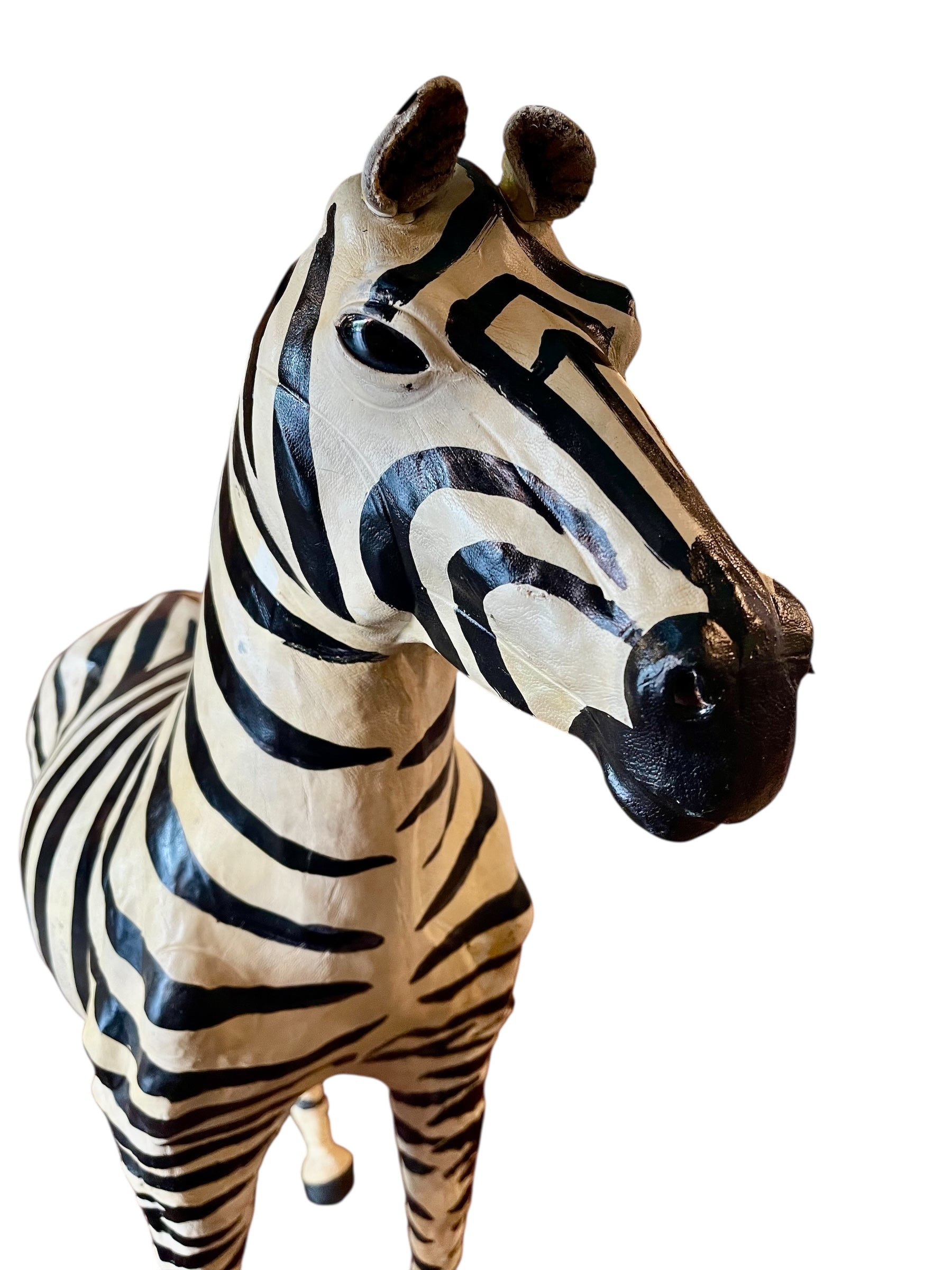 A full-length view of a standing zebra sculpture made from hand-painted leather. The sculpture features bold black and white stripes and shows signs of age, including slight yellowing and a tear on its leg.
Vintage
Antique
Art
Figurine
Decorative
Animal
Wear
Tear
Cream
Standing
Detailed
Full-length
Close-up
Zebra

stripes

striped

Sculpture

leather

hand painted

black and white

Animals

animal art

Hand Painted Leather Zebra Sculpture

Painted Leather Zebra Sculpture

Hand Painted Zebra Sculpture

Leath