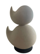 "Renzo Buttazzo's 'Lovers,' a sculpture made from Pietra Leccese featuring two stacked, rounded forms with subtle projections, on a black base."
"Modern sculpture of two smooth, light-colored forms stacked on top of each other, with a small horn-like protrusion on each."