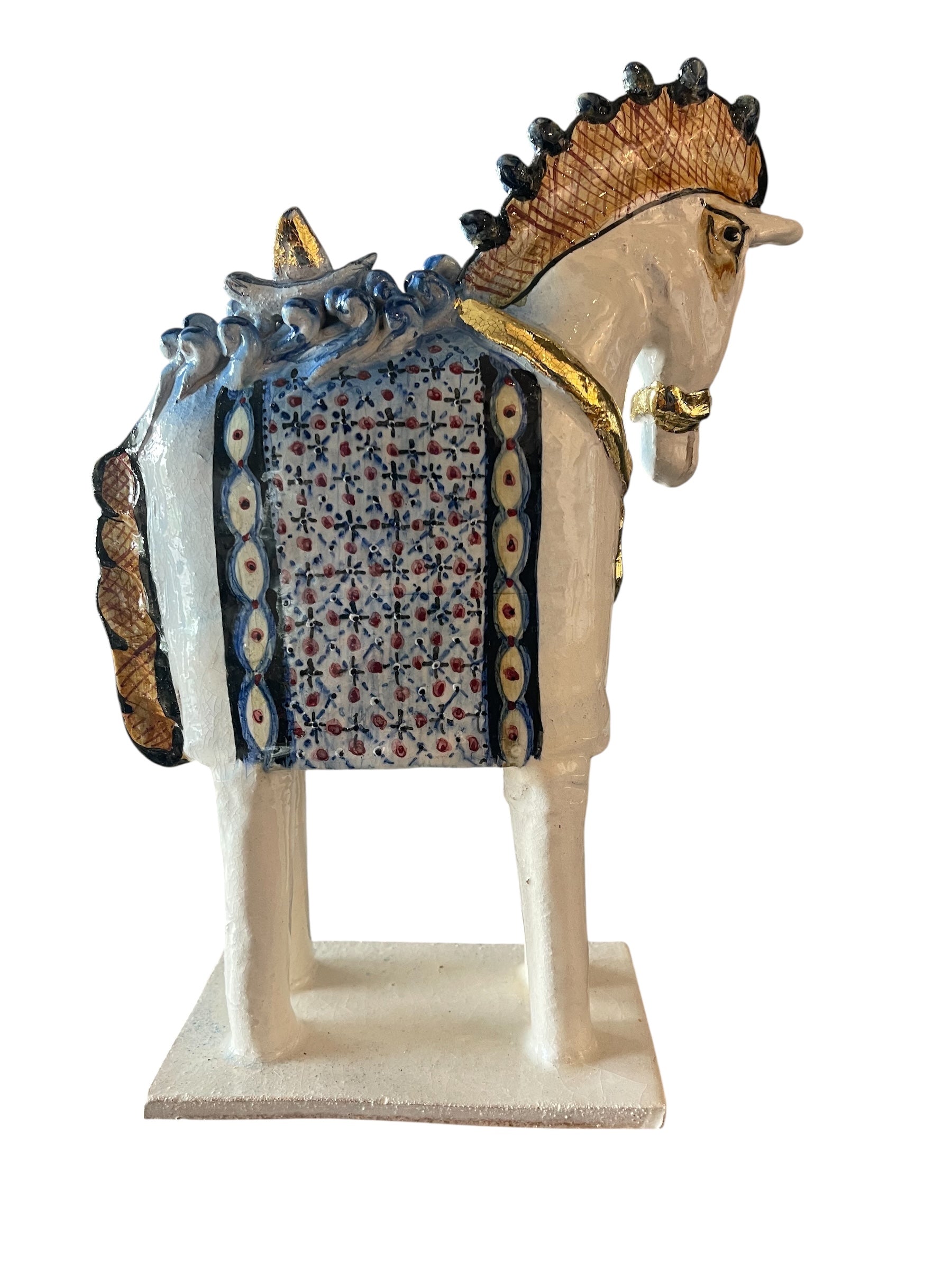 Ceramic horse by Domenico Pinto, featuring a white glazed body, geometric quilting on the saddle, gold accents, and 24Kt gold detailing. The horse stands on four legs and is placed on a white base.