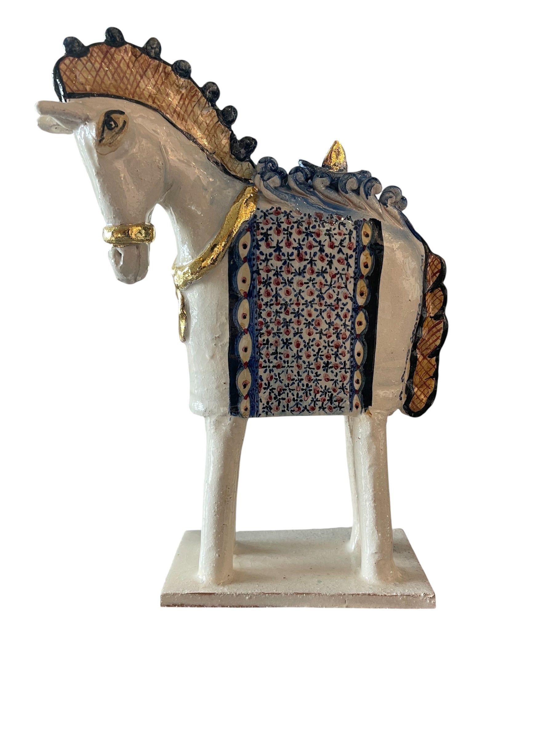 Ceramic horse by Domenico Pinto, featuring a white glazed body, geometric quilting on the saddle, gold accents, and 24Kt gold detailing. The horse stands on four legs and is placed on a white base.