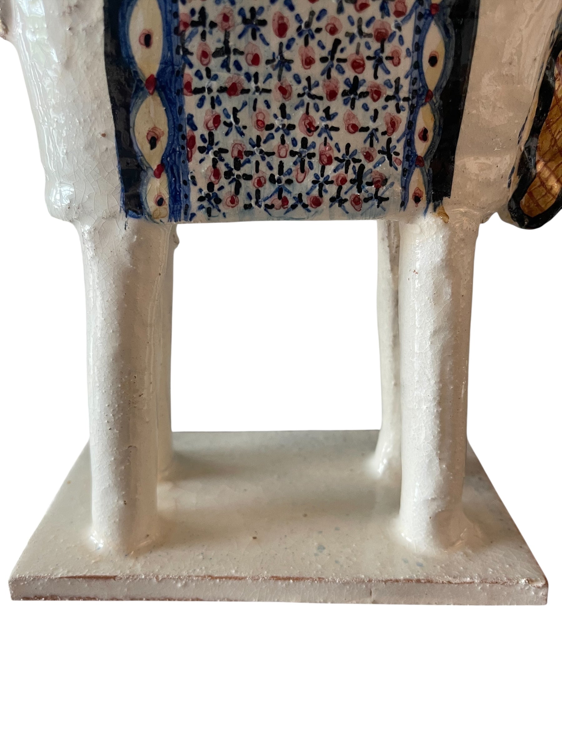 Ceramic horse by Domenico Pinto, featuring a white glazed body, geometric quilting on the saddle, gold accents, and 24Kt gold detailing. The horse stands on four legs and is placed on a white base.
