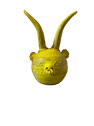 Yellow ceramic sculpture titled 'The Ram Oracle' by Enza Fasano, featuring a round body with intricate, hand-incised patterns and long, stylized ram-like horns.
L'Oracolo Ariete by Enza Fasano Ceramiche