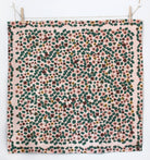 Floral patterned fabric hanging on a line with clothespins.