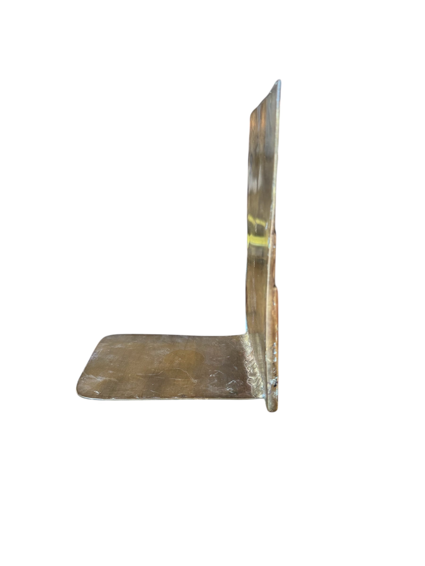 Close-up of two David Marshall Brutalist bookends. The bookends feature contrasting silver and bronze metal panels, separated by raised textured bronze seams. The bookends have a rough, geometric design.