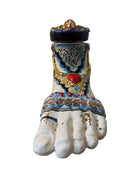Ceramic foot sculpture by Domenico Pinto featuring hand-painted details, gold accents, a sacred heart, and an angel figure with a blindfold
