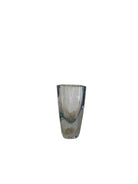 A vintage Strömbergshyttan crystal vase with a clear body and a fluid curve interior, standing on a flat surface.