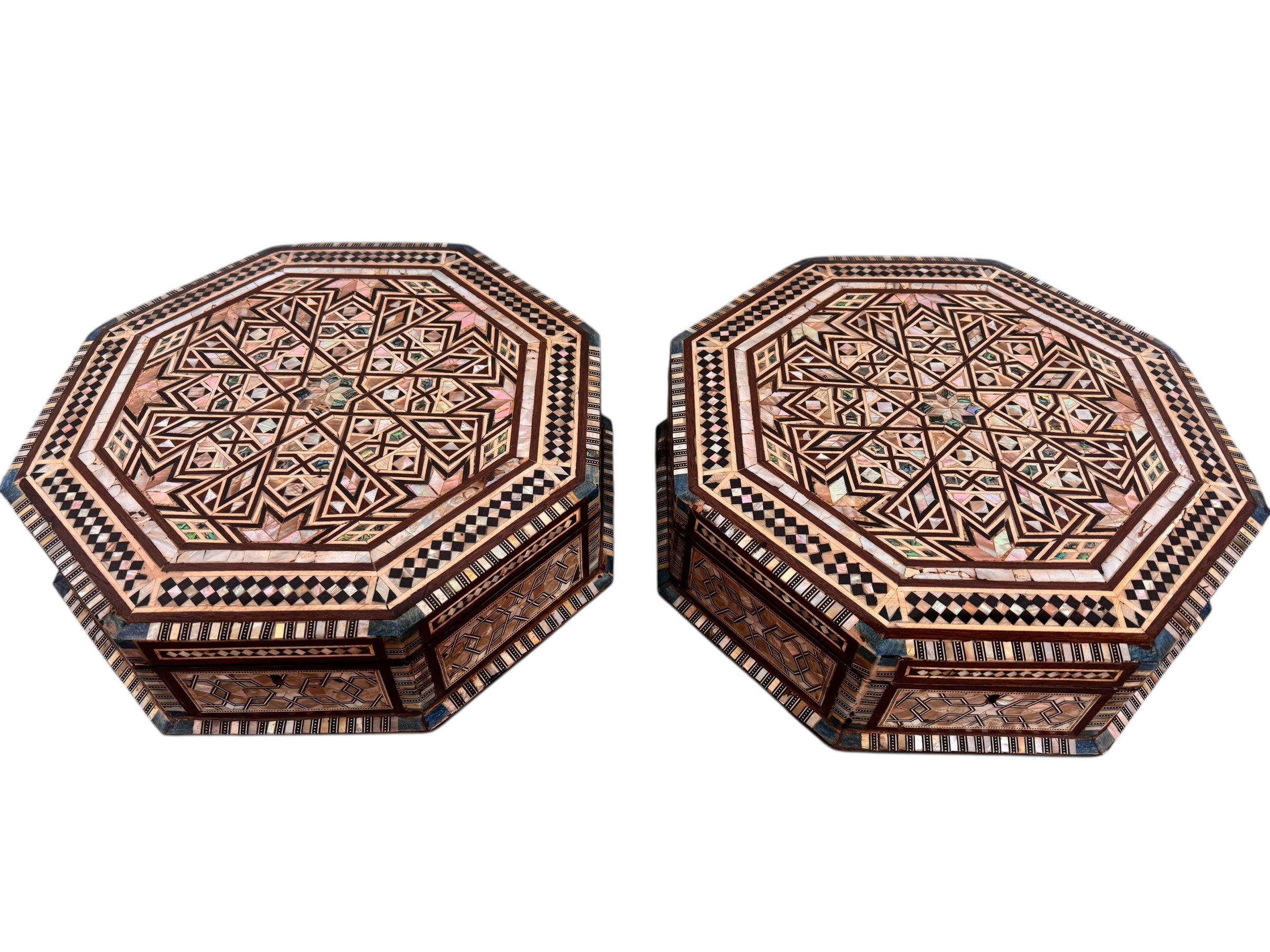 An ornate octagonal Syrian inlaid box, intricately decorated with geometric patterns made from dark wood, iridescent mother-of-pearl, vibrant abalone shell, and pale bone